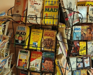 Vintage comic book and Ballantine Books paperback spinner racks