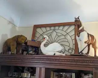 Heavily beveled and leaded glass window. Antique children's toys.