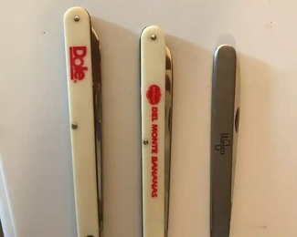 This and the next picture are of melon knives; two were promotional give-aways from fruit companies, the third of all stainless steel was probably purchased. It even includes a small sampling fork.