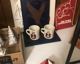 Mugs and yearbooks commemorating a group of Navy reconnaissance flight group.