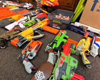 Large group of nerf and other brand toys with cartridges,  all appear in working condition and come with the pieces seen in photo and storage containers for pieces 