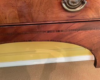 A George IV mahogany bow fronted sideboard, 19th century, with arched napery drawer, left drawer, cellaret on right, on four tapered and ring turned legs.