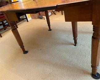 This table is soooo charming that my clients used it for their formal dinning  table with 8 antique Chippendale formal chairs.  An antique 19th century solid walnut oval drop leaf extension table with 5 legs and 4 leaves. Solid walnut five turned legs. Four solid walnut original leaves. Table is in a clean original finish. Original casters. Original custom primitive drop leaf brackets. All original parts and in good working order.  This table has a super charming primitive patch on the main table surface.