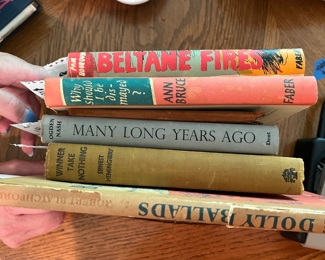 Tucked in this stack, you will see a first edition Ernest Hemingway book - unsigned.  There is also the coolest suede covered tiny book of love poems.