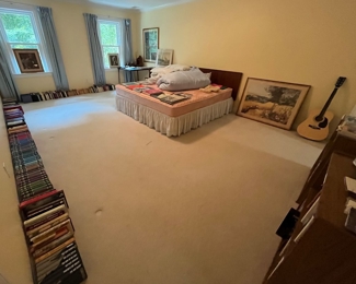 A room full of various books including loads of "Folio" books.  Additionally there is also a fabulous King sized MCM headboard.