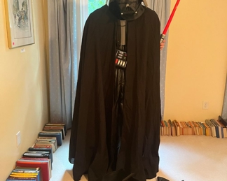 Professional Darth Vader costume.  Boots, Gloves, complete gear under the cape.  You could really fool someone with this one!  He is also equipped with two lightsabers as well.
