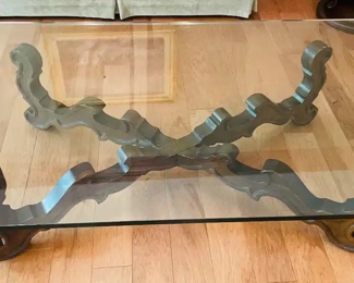 $200 	
#10 Mediterranean style wood base stretcher coffee 									
table with thick 1/2"beveled glass top 66x36x16"	