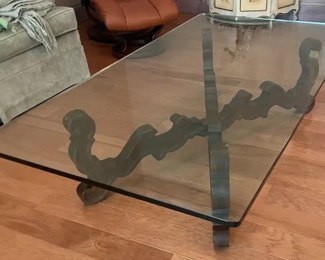 $200 	
#10 Mediterranean style wood base stretcher coffee 									
table with thick 1/2"beveled glass top 66x36x16"	