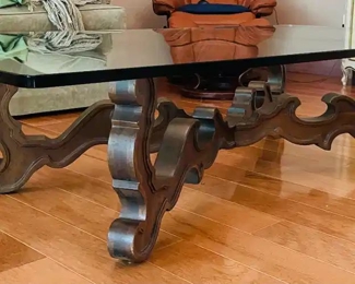 $200 	
#10 Mediterranean style wood base stretcher coffee 									
table with thick 1/2"beveled glass top 66x36x16"	
