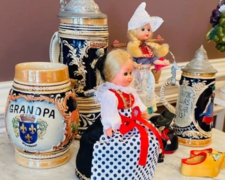 $60 	"
#64 German lot Steins, & dolls 7 pieces "	