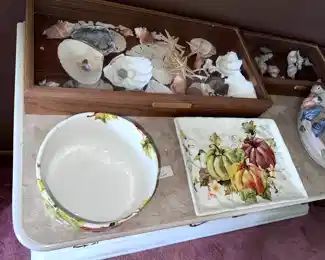 ceramic serving dishes, sea shells in display cases,
