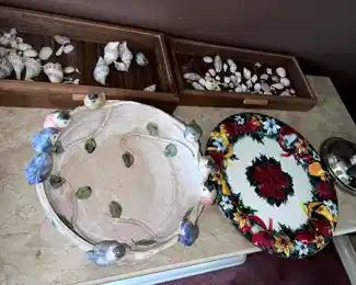 ceramic serving dishes, sea shells in display cases,
