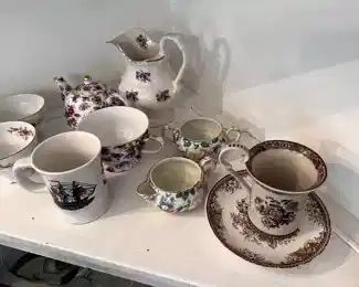 tea cups and saucers, cream and sugar cups, tea pot, pitcher.