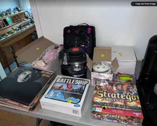 Classic rock records, battleship board game (new), Stratego board game (new), lanterns, electric men's heated jacket 3XL, antique doll, potpourri warmer, bird feeder.