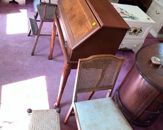 antique desk, wicker chair, small foot stool,