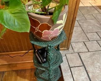 Iron plant stand 
Large assortment of decorative planters 