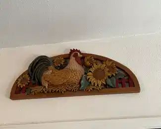 Carved wooden sign with rooster