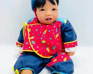 GOTZ Carlos Baby Doll Signed and Numbered 90/734 on the back of the neck. The d oll has brown glass eyes and eyelashes and hair. It has an incredibly lifelike face with moist lips, tongue teeth and even a most noise.
