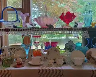The living room china and glass table features Fenton,  Shelly and more !