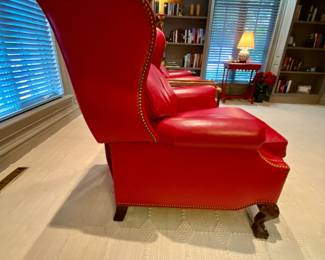 Side profile view of red leather recliner chair with motion 