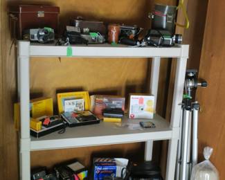 Many vintage cameras, Kodak, Polaroids, 8mm projectors.