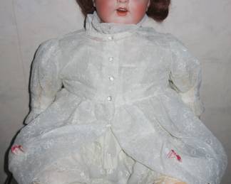 Antique doll, bisque head with cloth body. Marked Germany K&K 60 Thuringia. Doll has a repair on back of neck. 