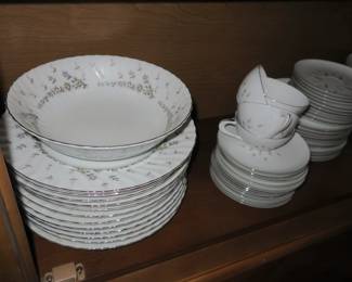 Two similar sets of china. Love the simple pattern in colors of pink, black & gray. 