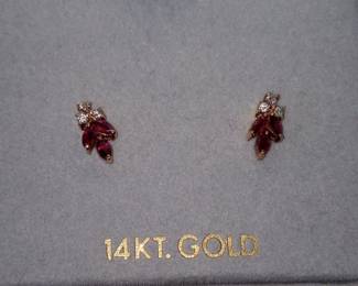 14k yellow gold 3 marquise shaped rubies with diamonds.