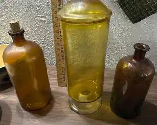 very large apothecary bottles and covered jar, amber
