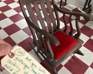 sturdy old rocker with grotesque faces