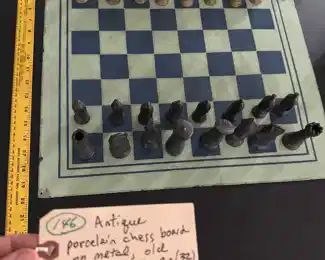 beautiful old porcelain checkerboard and heavy metal chess pieces set