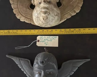 carved wooden winged heads