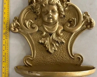 old cast iron wall planter with cherub face