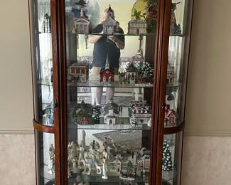 A beautiful curio cabinet FILLED with an adorable Christmas village and more!