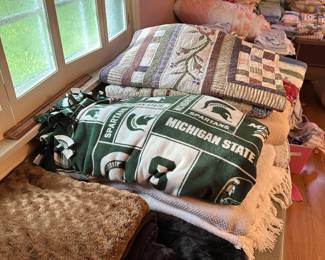 Here are several tables COVERED with blankets and quilts! 