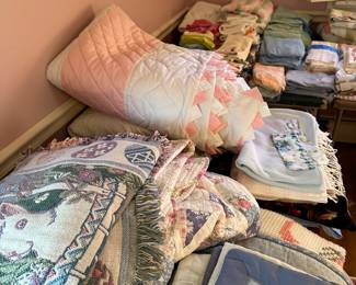 Here are several tables COVERED with blankets and quilts! 