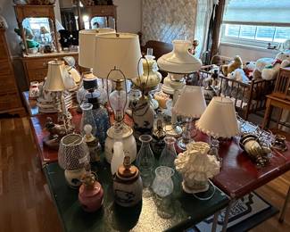 This is an electrifying picture of our collection of lamps! Lamps of ever sized shape and color! Vintage to contemporary, pairs to singles and LOTS of  lamp shades! 