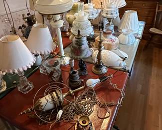 This is an electrifying picture of our collection of lamps! Lamps of ever sized shape and color! Vintage to contemporary, pairs to singles and LOTS of  lamp shades! 