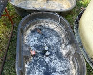 A Pair of rubbermaid 50 gallon stock tanks w/ water heaters.