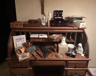Here is a great rollmop desk! It is covered with lots of Religious paraphernalia, jewelry boxes and more!