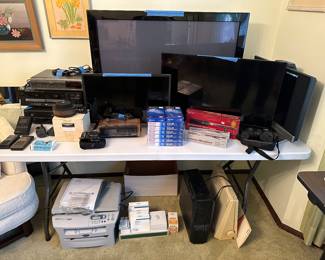 Electronics area! 4 flat screens, VHS, Duel Cassette Deck, and a 5 Disk Changer! Also some GREAT cameras, microphones and other assorted items!