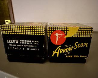 Here is a pair, in their original boxes, 35mm Slide Viewers! These are absolutely MCM! Both are red and black swirled Bakelite!