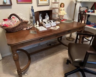 Oversized wooden Revel’s Furniture desk with Office Star studded, adjustable height, rolling office chair 