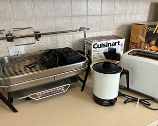 Kitchen appliances including a Farberware rotisserie indoor grill…