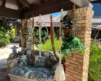 Macrame plant hangers, rattan sofa and end table