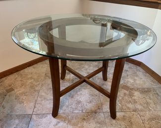 42" diameter x 30"H  glass table with wood base. 