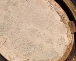 the back of the miniature does have a name, which I cannot read.