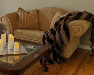 Bombe style love seat with rolled arms. Taupe brocade.