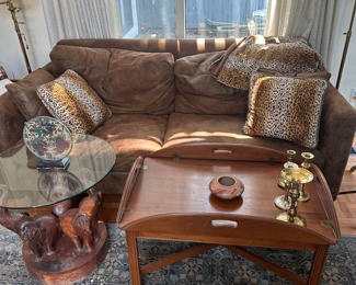 Cute elephant and glass accent table, nice comfy couch, coffee table area rug