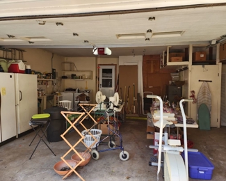 garage is full of stuff including washer and dryer, GE, Freezer and another refrigerator
